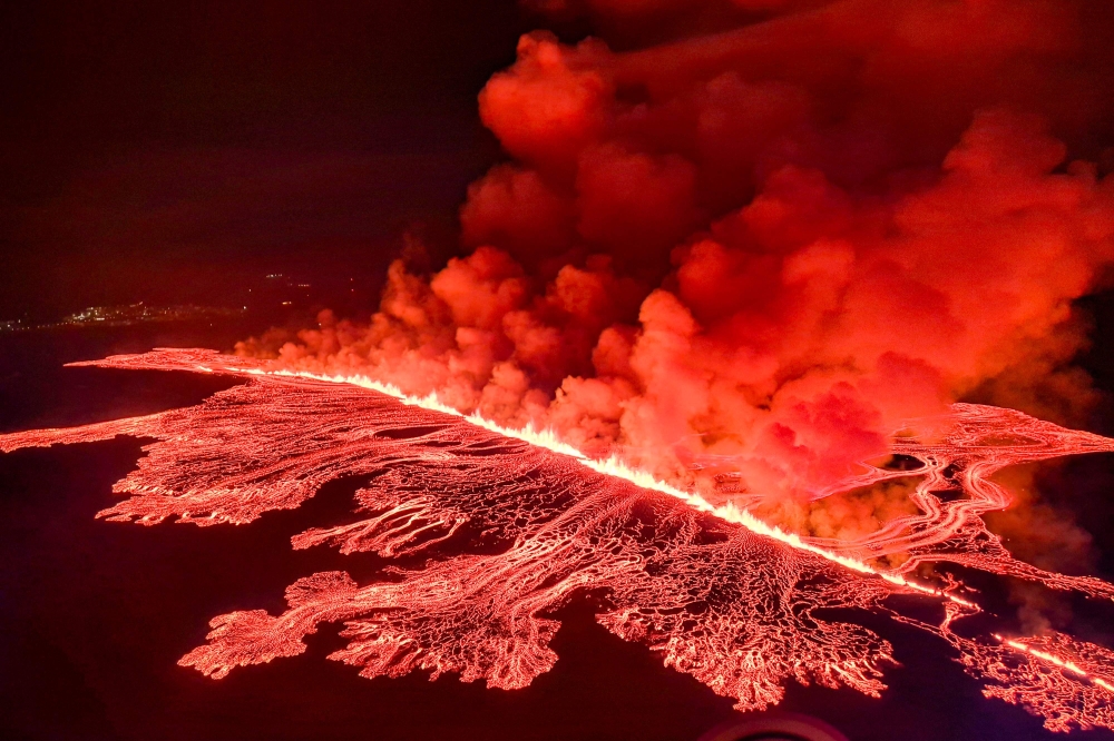 This handout picture released by the Icelandic Coast Guard on March 16, 2024 shows billowing smoke and flowing lava pouring out of a new fissure. — AFP pic/Icelandic Coast Guard handout