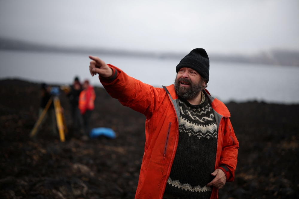 Erik Sturkell, a geophysicist at the University of Gothenburg in Sweden, gestures as he works on a lava field at the Askja volcano in Vatnajokull National Park, August 9, 2024. — Reuters pic  