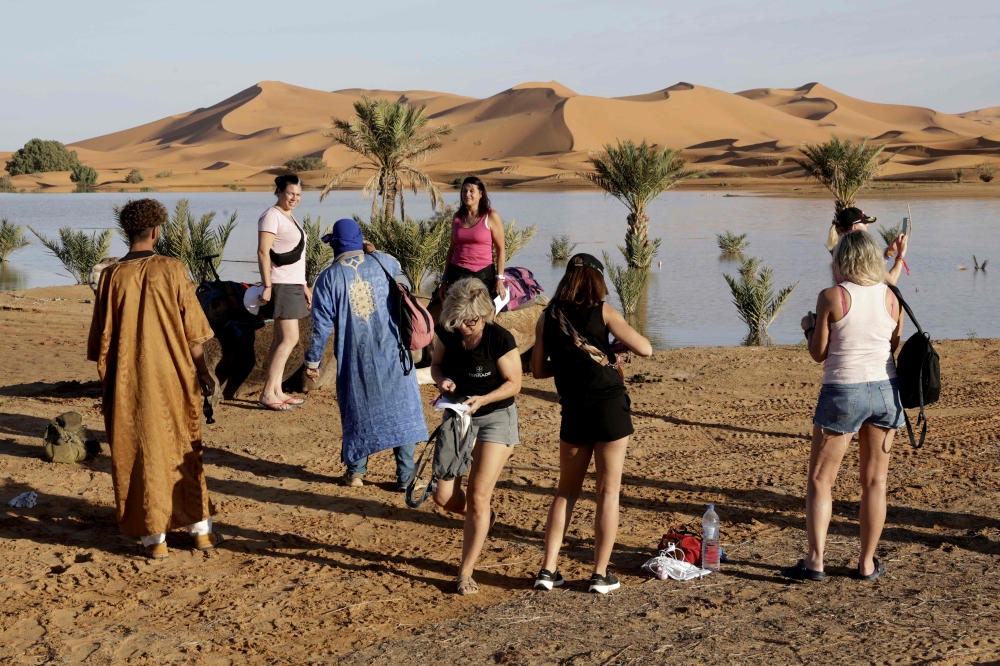 Tourists visit Yasmina lake, a seasonal lake in the village of Merzouga in the Sahara desert in southeastern Morocco on October 20, 2024. — AFP pic