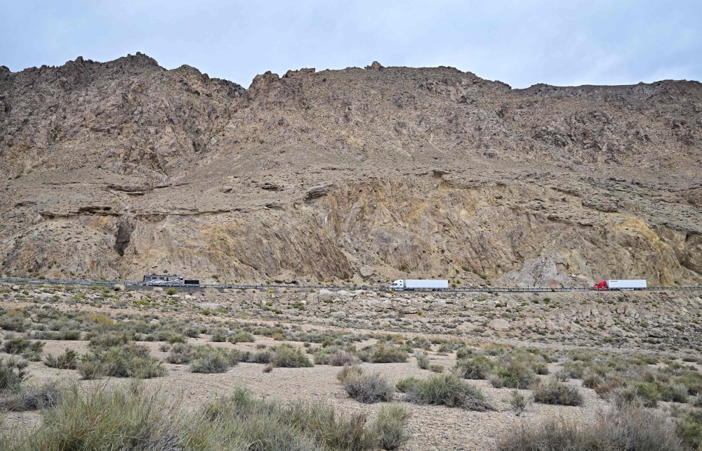 Eighteen-wheelers cross the Nevada landscape in Mineral County near Walker Lake outside of Hawthorne, travelling the north-south US Route 95 highway linking Reno with Las Vegas on October 16, 2024. A full tank in the US is more than double the cost in Malaysia.— AFP pic