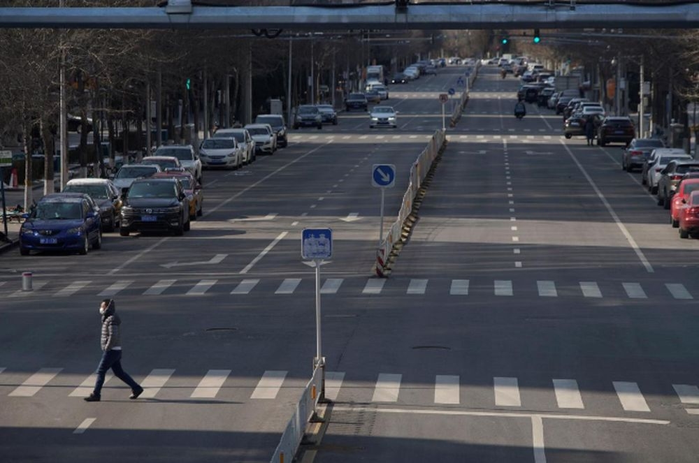 A man wearing a face mask crosses a road in Beijing February 15, 2020. China’s fuel prices are rising but remain more affordable than Hong Kong’s. — Reuters pic