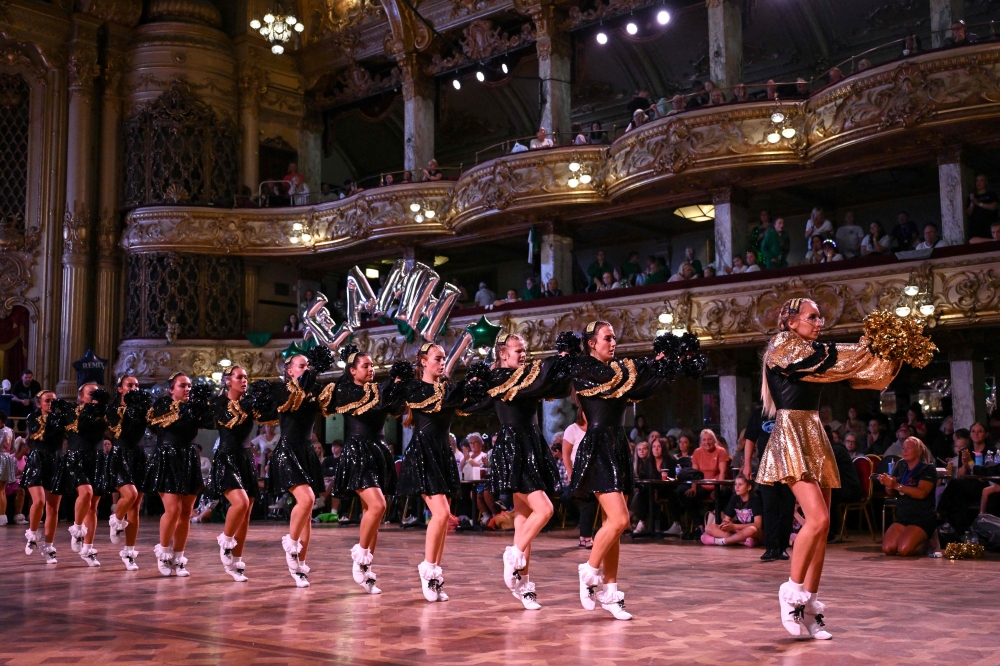 Members of the Platt Bridge Carnival Morris dancing group, competing in the Senior Division 1 category, perform during in the Remix End of Season Championships at the Blackpool Tower Ballroom, in Blackpool September 15, 2024. — AFP pic