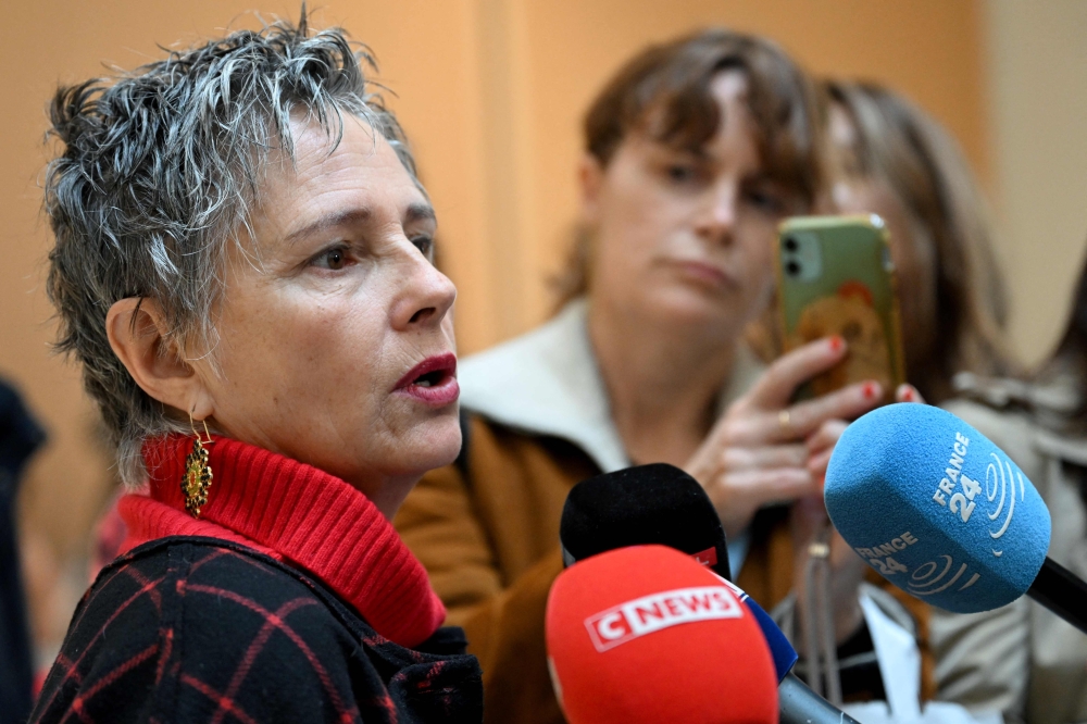 French actress Anouk Grinberg speaks with the media outside the criminal court where French actor Gerard Depardieu will be tried on sexual assault charges, in Paris on October 28, 2024. — AFP pic