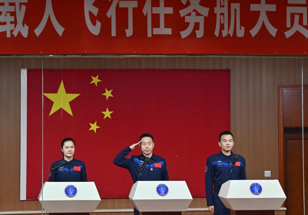 (From left) Astronauts Wang Haoze, Cai Xuzhe and Song Lingdong attend a press conference a day before the Shenzhou-19 mission at the Jiuquan Satellite Launch Centre in the Gobi desert October 29, 2024. — AFP pic