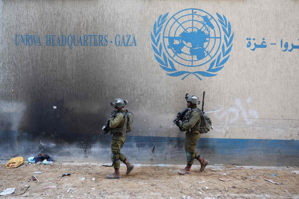 This picture taken during a media tour organised by the Israeli army on February 8, 2024, shows Israeli soldiers inside an evacuated compound of the United Nations Relief and Works Agency for Palestine Refugees (UNRWA) in Gaza. — AFP pic