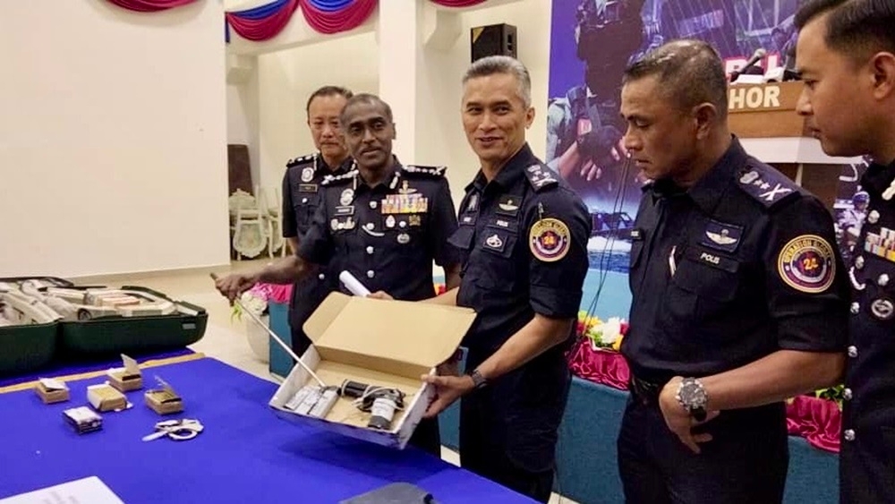 Bukit Aman Criminal Investigation Department (CID) director Datuk Seri Mohd Shuhaily Mohd Zain (3rd left) with a seized firearm and part of the ransom that was recovered from the suspects of a kidnapping case during a media conference held at the Johor police contingent headquarters in Johor Baru October 30, 2024. — Picture by Ben Tan 