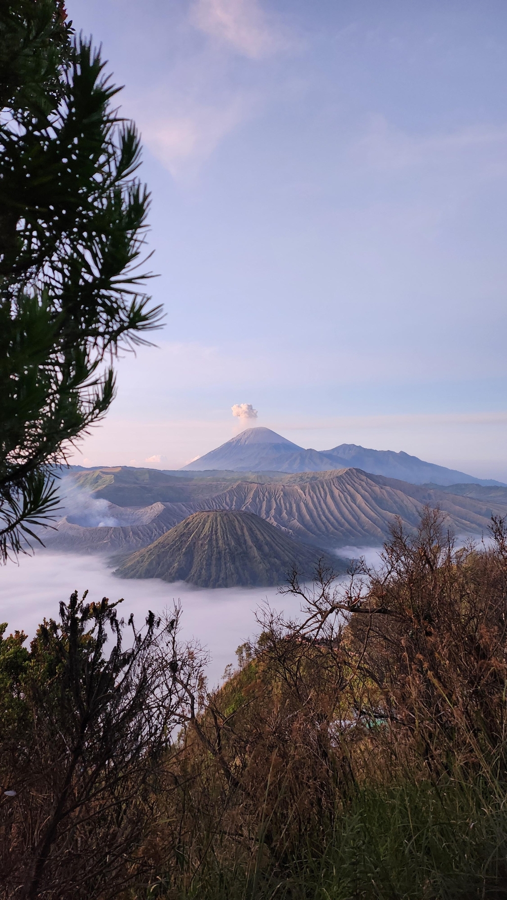 Nur Syaireen Natasya Azaharin's winning picture shows a small pyrocumulus cloud sitting atop Mount Semeru (central peak in the background) as small plumes of smoke and steam emit from the crater of Mount Bromo.