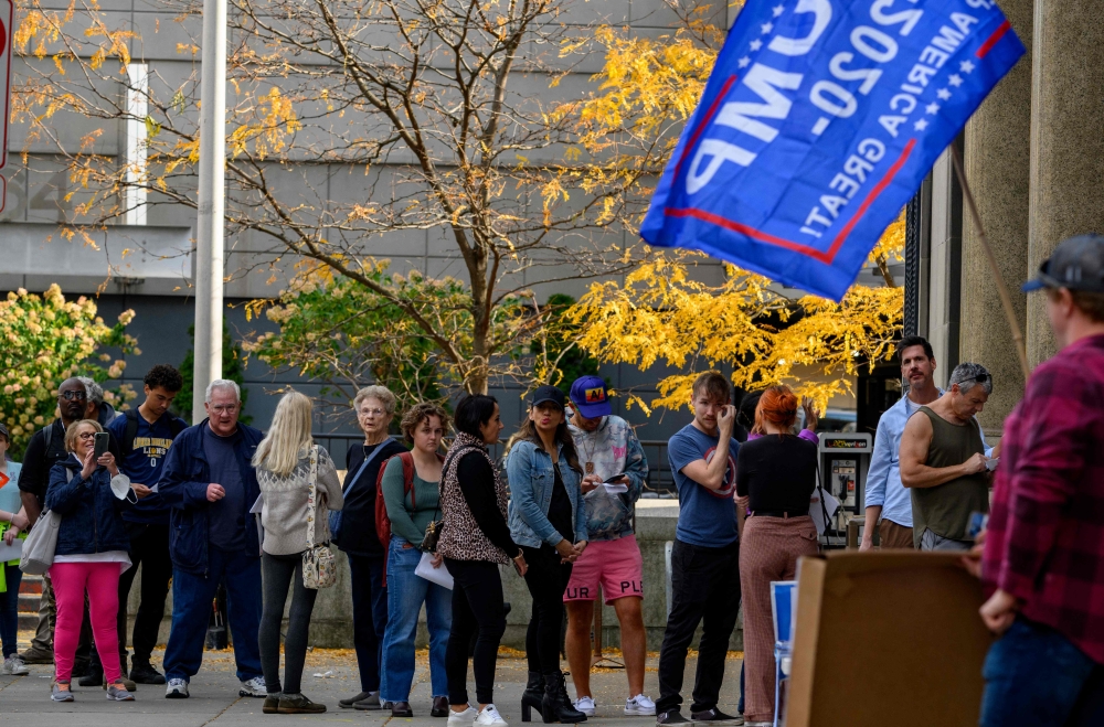 Voters line up to apply for their mail-in or absentee ballots outside the Allegheny County Office Building on October 29, 2024 in Pittsburgh, Pennsylvania. — AFP pic