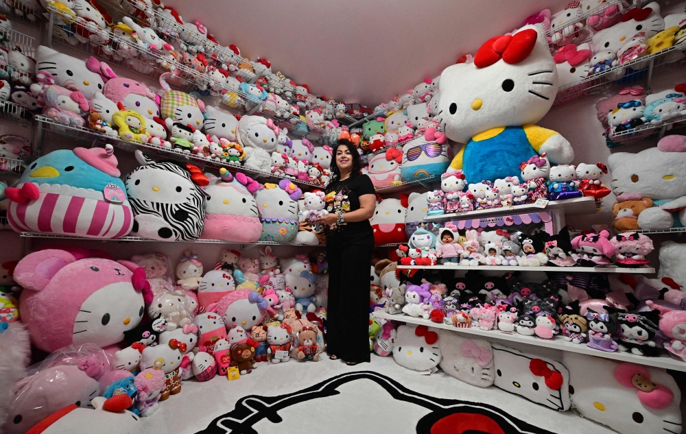 In this picture taken on October 19, 2024, Helen, founder of the ‘Hello Kitty SoCal Babes’ fan club, poses with her collection inside her ‘she-shed’ in Riverside County, California. — AFP pic