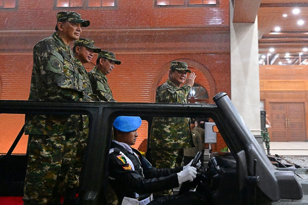 This handout picture taken and released by Indonesia's presidential palace on October 25, 2024, shows president Prabowo Subianto (right) flanked by defense minister Sjafrie Sjamsoeddin (left), general Agus Subiyanto commander-in-chief of Indonesian army (2nd left) and police commissioner general Listyo Sigit Prabowo (centre), at the military academy during their cabinet retreat in Magelang, Central Java. — Presidential Palace handout pic via AFP