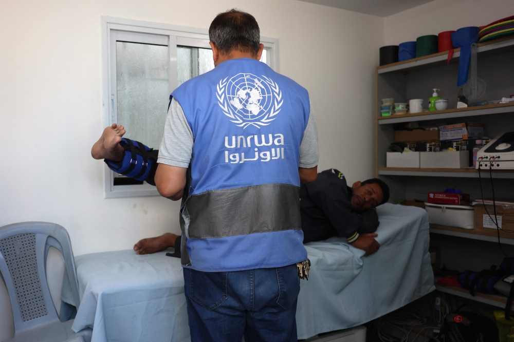 A physiotherapist helps a Palestinian man at the UNRWA Japanese Health Center in Khan Yunis on the southern Gaza Strip on October 29, 2024, amid the ongoing war between Israel and the Palestinian group Hamas. — AFP pic