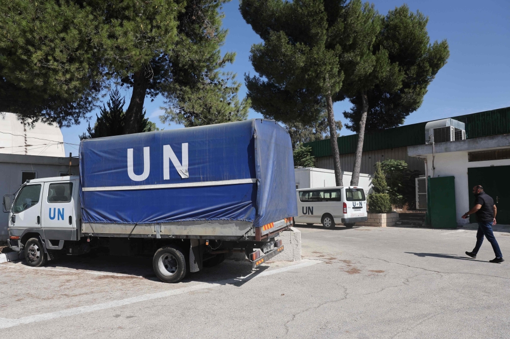 A man next to a truck at the UNRWA (United Nations Relief and Works Agency) West Bank Field Office in Jerusalem on October 29, 2024. — AFP pic