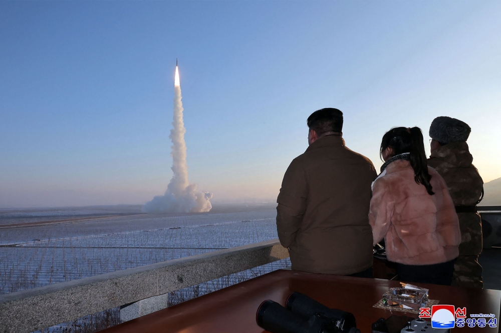 This undated picture released by North Korea's official Korean Central News Agency (KCNA) on December 19, 2023 shows North Korean leader Kim Jong-un and his daughter watching the test launch of a Hwasongpho-18 intercontinental ballistic missile (ICBM) at an undisclosed location in North Korea. — AFP pic