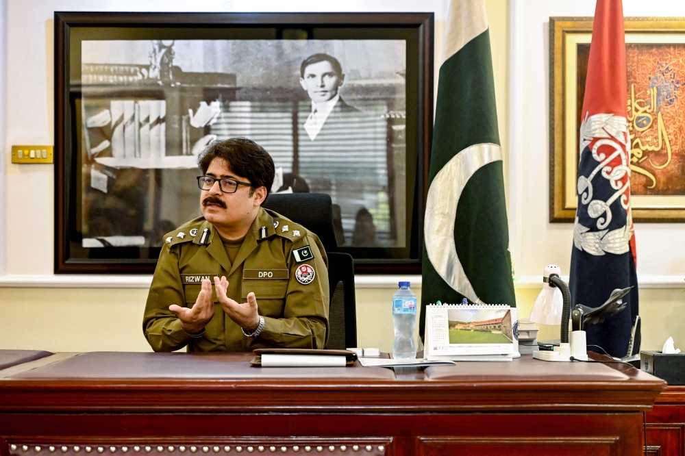 This photograph taken on October 9, 2024 shows local district police officer Rizwan Gondal speaking during an interview with AFP at his office in Rahim Yar Khan district. — AFP pic