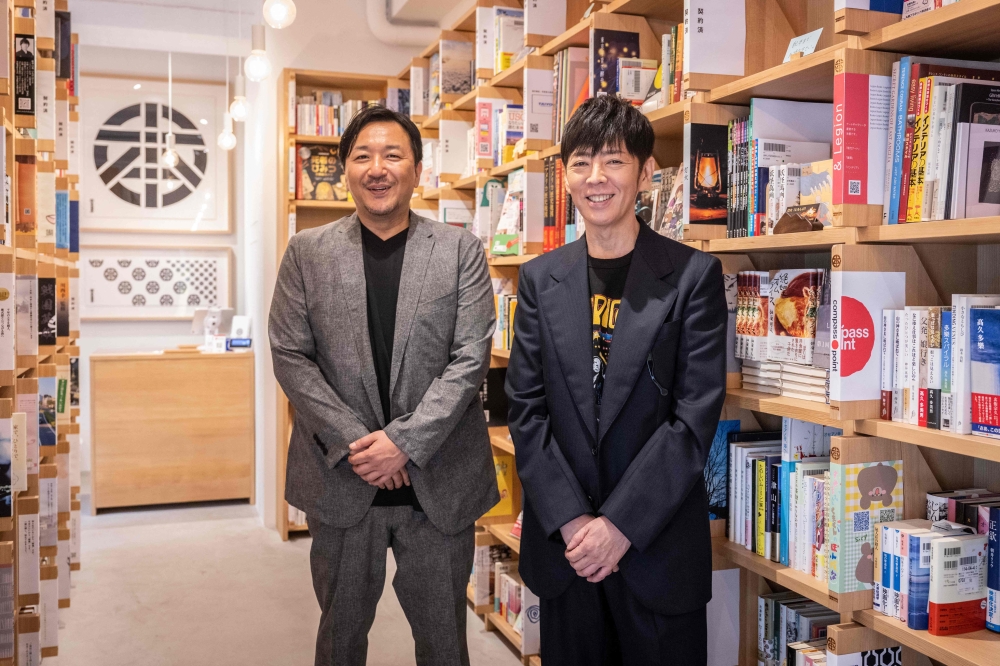 This picture taken on July 18, 2024 shows (from left) bookshop owner and novelist Shogo Imamura and creative director Kashiwa Sato posing for photographs at bookstore ‘Honmaru Jimbocho’ in Tokyo. — AFP pic