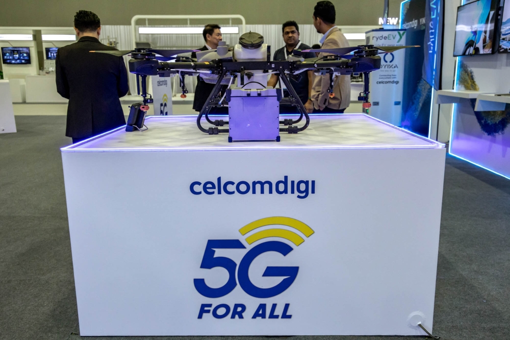 The CelcomDigi logo is seen during the Huawei Malaysia ICT Summit 2023 Exhibition at MITEC in Kuala Lumpur on September 27, 2023. — Picture by Firdaus Latif