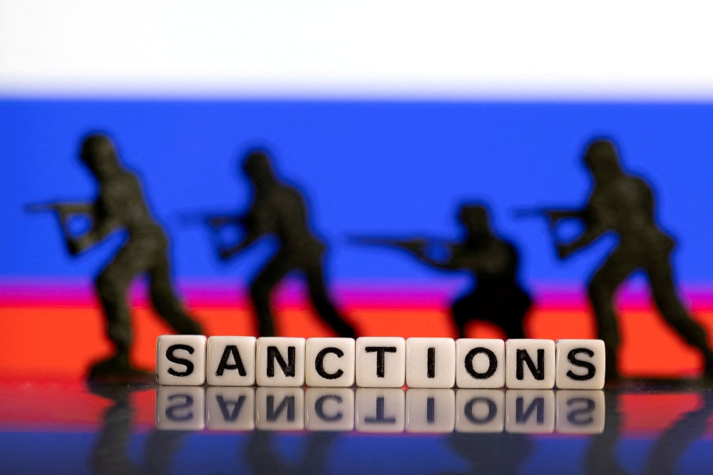 An illustrative file photo shows letters arranged to form the word ‘sanctions’ with toy figures in the background.  — Reuters pic