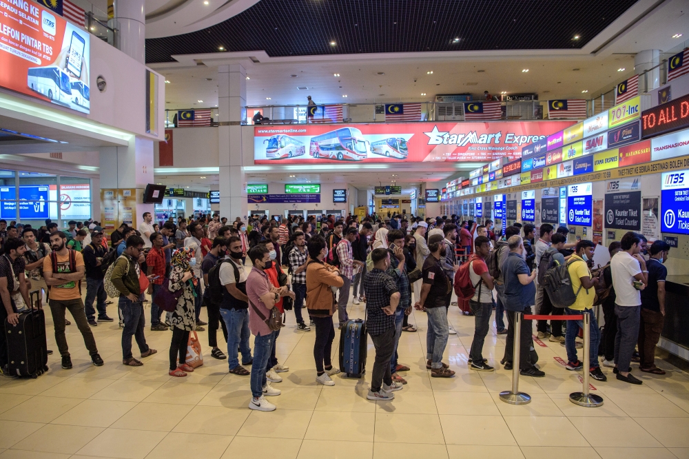 A file photograph shows people queueing to buy tickets at a bus terminal in Kuala Lumpur, on August 11, 2023. — Bernama