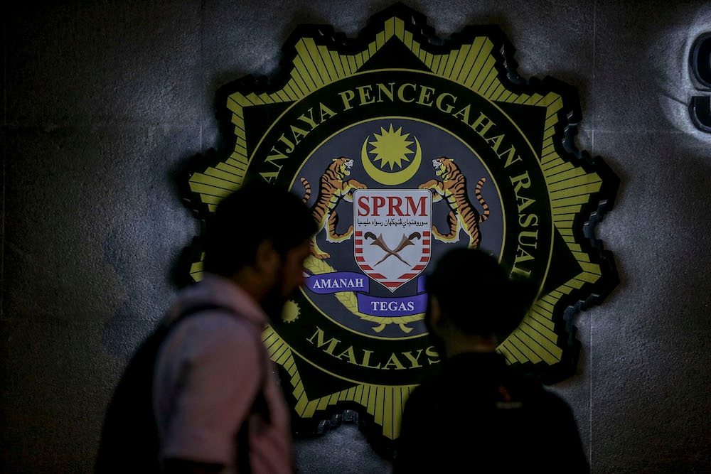 According to an MACC source, the two male suspects, between 50 and 60 years old, were arrested around 8.30pm when they presented themselves at the MACC headquarters in Putrajaya to have their statements recorded. — Picture by Hari Anggara