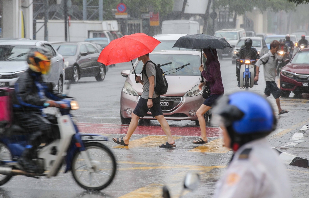 Thunderstorms, heavy rain and strong winds are expected in the federal capital and eight states until noon today. — Picture by Farhan Najib