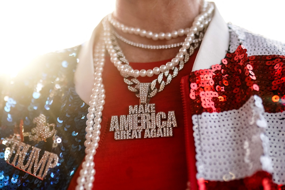 TOPSHOT - A supporter displays a bejeweled 'Make America Great Again' necklace at a campaign event by former US President and Republican presidential candidate Donald Trump in Macon, Georgia, on November 3, 2024. — AFP pic