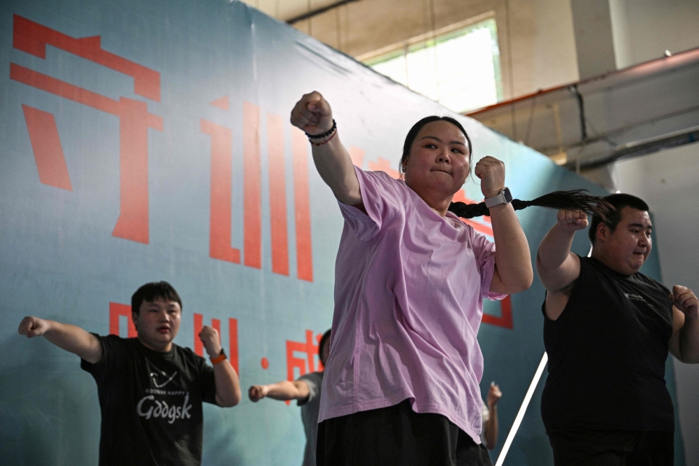 Boasting strict daily exercise regimens, mandatory trips to the scale and rigid surveillance to guard against snacking, weight loss camps have popped up across China. — AFP pic