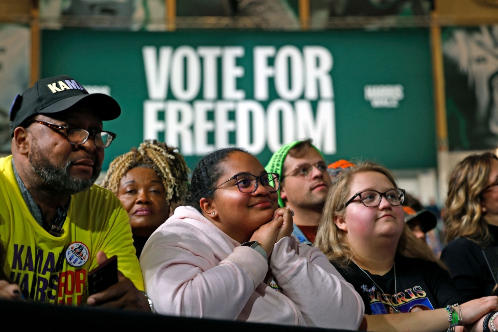 Supporters listen to US Vice President and Democratic presidential nominee Kamala Harris speak during a campaign rally at Michigan State University's Jenison Field House in East Lansing, Michigan, on November 3, 2024. — AFP pic