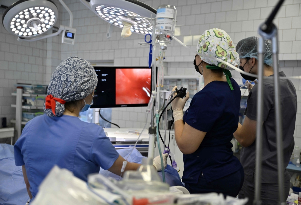 Medical staff at the septic surgery department of the Mechnikov Hospital in Dnipro check a patient on September 26, 2024, amid the Russian invasion of Ukraine. — AFP pic