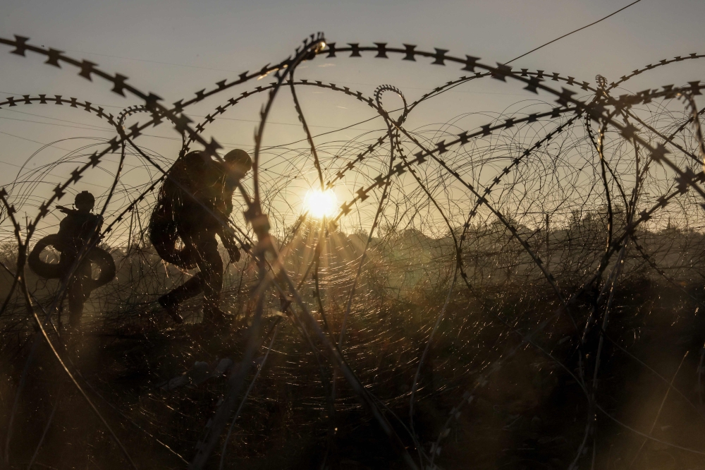 This handout photograph taken and released by the Press service of the 24th mechanized brigade named after King Danylo of the Armed Forces of Ukraine on October 30, 2024 shows engineers installing razor wire along the frontline in the Donetsk region, amid the Russian invasion in Ukraine. — AFP pic