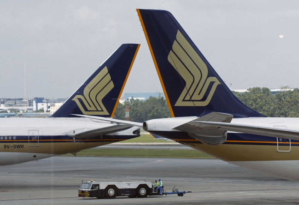 A file photograph shows Singapore Airlines (SIA) planes on the tarmac in Singapore's Changi Airport. — Reuters pic