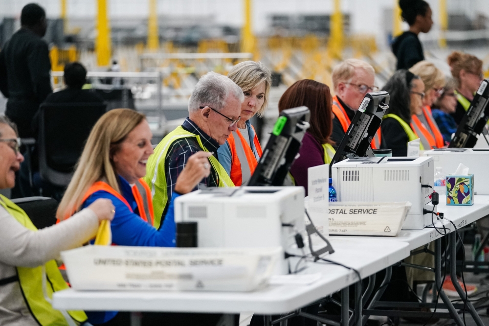 Fulton County elections workers process absentee ballots at the new Fulton County Elections Hub and Operations Center on November 4, 2024 in Union City, Georgia. — AFP pic