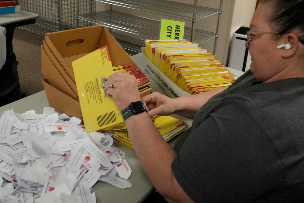 An election worker processes boxes of mail-in ballots at the Salt Lake County election offices in Salt Lake City, Utah, on November 4, 2024. — AFP pic