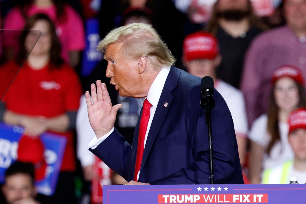 Former US President and Republican presidential candidate Donald Trump gestures as he speaks during a campaign rally at Van Andel Arena in Grand Rapids, Michigan on November 5, 2024. — AFP pic