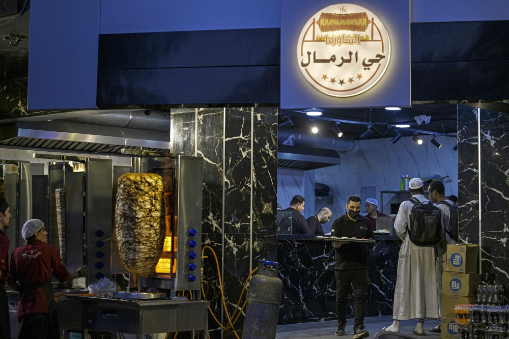 Many cafes, falafel joints, shawarma spots and sweets shops have opened up in Cairo’s Nasr City neighbourhood. — AFP pic