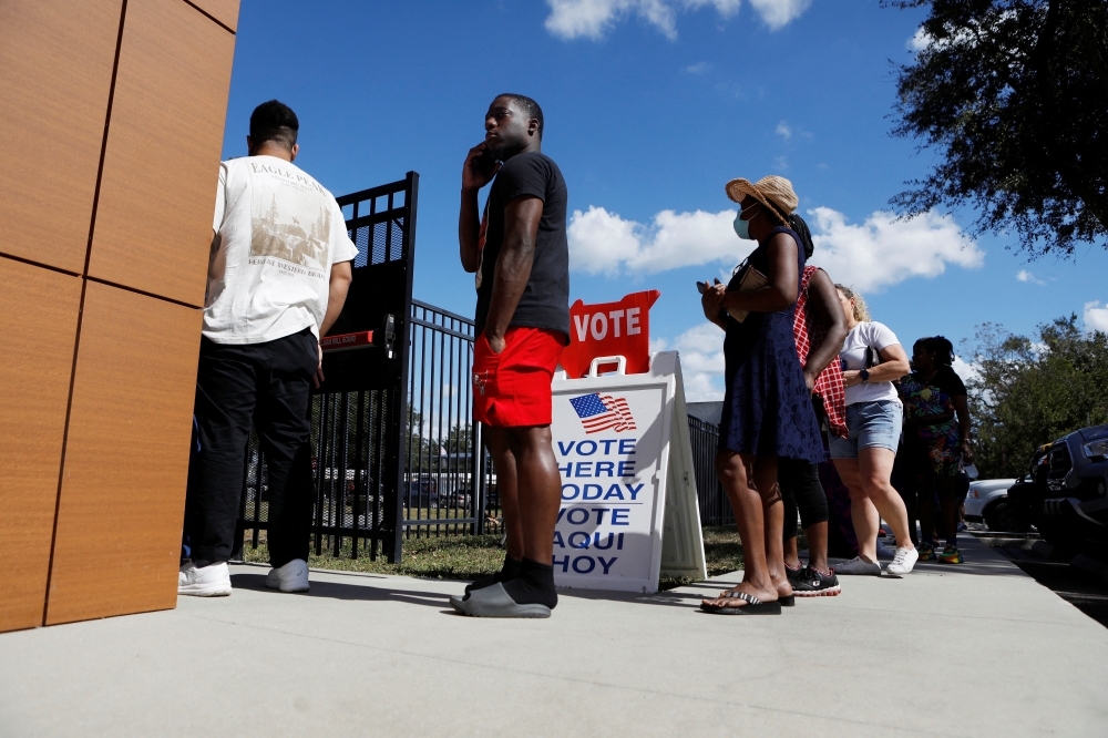 An African American man waits in line with other community members in East Tampa to enter the C. Blythe Andrews, Jr. Public Library at a early voting polling precinct to cast their ballots in local, state, and national elections in Tampa, Florida, U.S., November 2, 2024. — Reuters pic