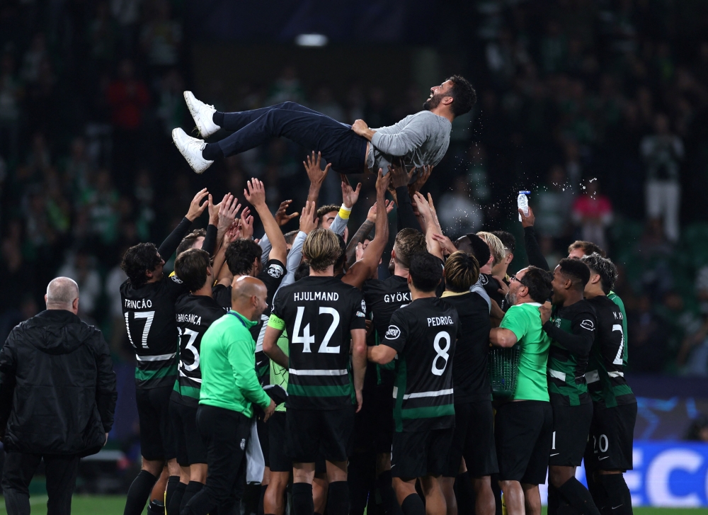 Sporting Lisbon’s manager Ruben Amorim is celebrated by his players at the end of the Uefa Champions League match with Manchester City in Lisbon November 5, 2024. — AFP pic