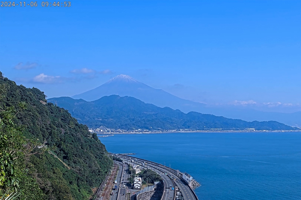 This screen grab taken from a live video stream broadcast by the Shizuoka City Government on November 6, 2024 shows Mount Fuji with a dusting of snow on its peak, as seen from the Shizuoka City side of the mountain. — AFP pic