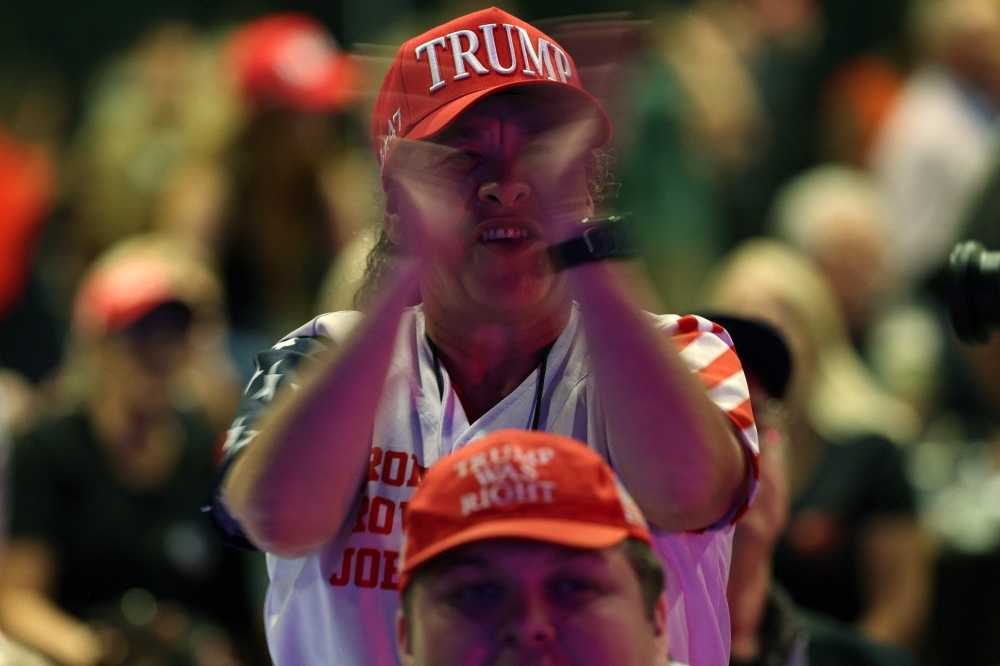 Supporters react while watching returns come in during an election night watch party for Republican presidential nominee, former US President Donald Trump at the Palm Beach Convention Center in West Palm Beach, Florida November 5, 2024. — AFP pic 