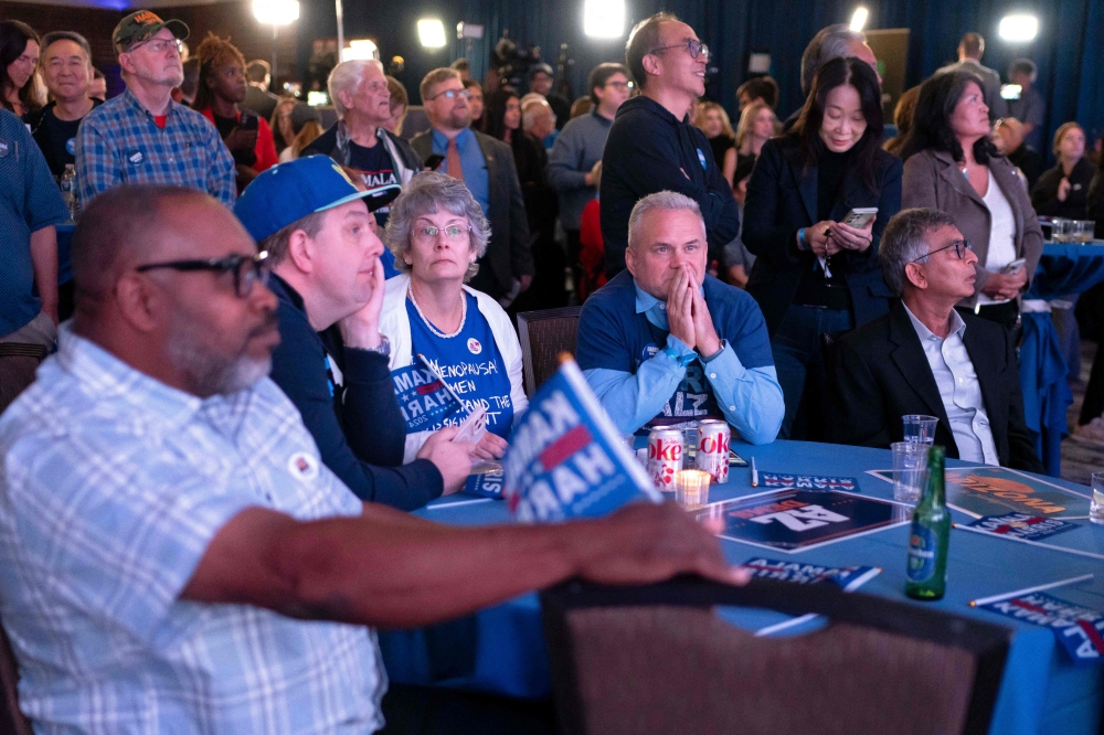 Attendees watch early election results during the Arizona Democratic Party’s Election Night watch party in Phoenix, Arizona, November 5, 2024. — AFP pic