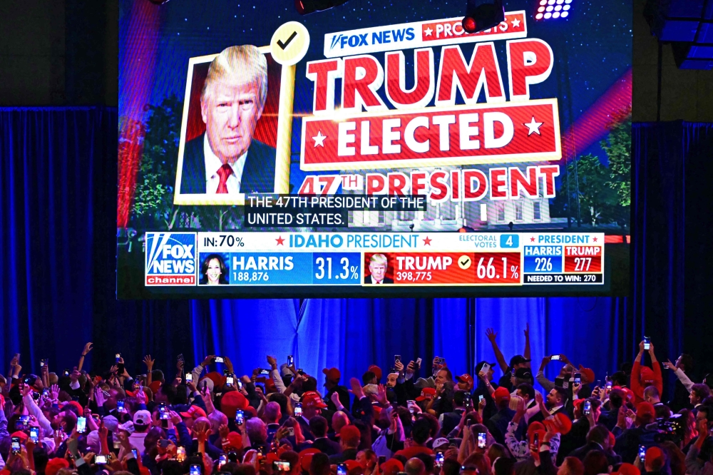 Supporters of former US president and Republican presidential candidate Donald Trump celebrate as Fox News declares him the next President of the United States during an election night event in West Palm Beach, Florida, early on November 6, 2024. — AFP pic