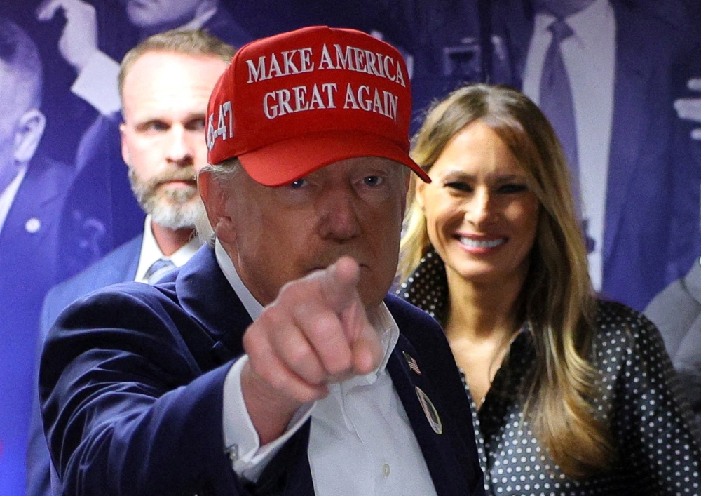 Republican presidential nominee and former US President Donald Trump, accompanied by former US first lady Melania Trump, visits his campaign headquarters to thank the campaign workers on Election Day, in West Palm Beach, Florida, November 5, 2024. — Reuters pic