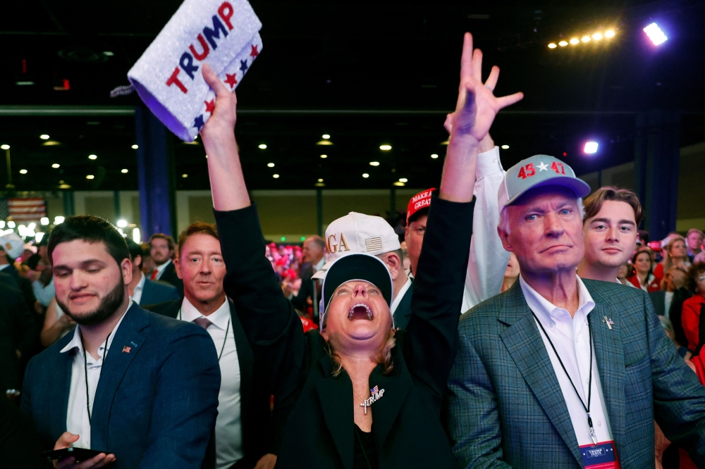 Supporters react while watching results come in during an election night watch party for Republican presidential nominee, former US president Donald Trump in West Palm Beach, Florida November 5, 2024. — AFP pic 