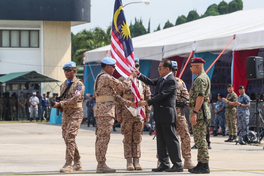 The Malaysian Battalion 850-12 (MALBATT 850-12) Commander Colonel Johan Effendi Mohd Shalleh receives a Malaysian flag from Defence Minister Datuk Seri Mohamed Khaled Nordin during a ceremony before leaving to Lebanon at the Royal Air Force base in Subang today. — Picture by Yusof Mat Isa