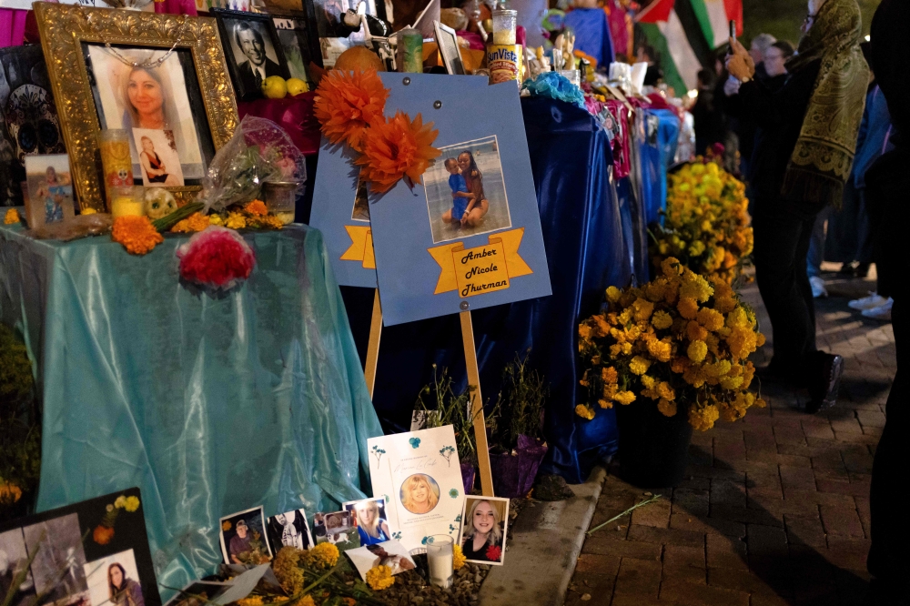 Pictures of women who died due to abortion restrictions are left at a community altar during the 2024 All Souls Procession in Tucson, Arizona, November 3, 2024. — AFP pic