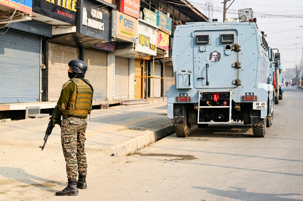 An Indian security personnel stands guard near the site of a gunbattle between suspected militants and Indian forces in Srinagar on November 2, 2024. — AFP pic