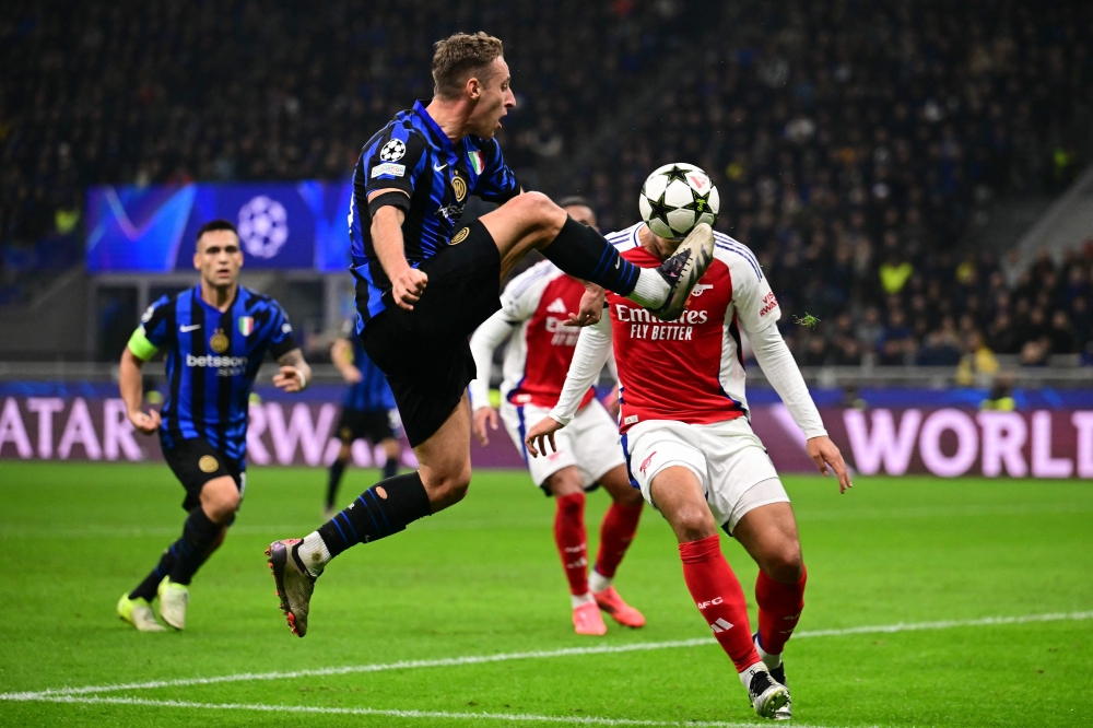 Inter Milan’s Davide Frattesi fights for the ball with Arsenal’s William Saliba during their Uefa Champions League match at the San Siro stadium in Milan November 6, 2024. — AFP pic