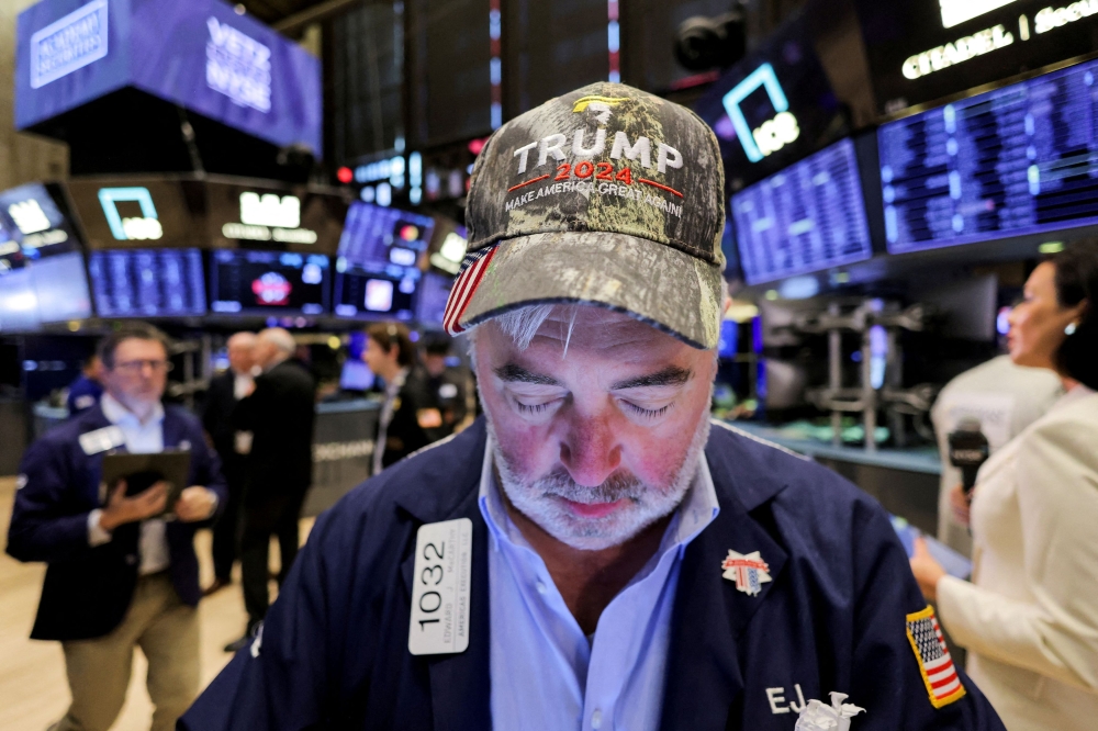 A trader wears a hat in support of Republican Donald Trump, after he won the US presidential election, at the New York Stock Exchange in New York November 6, 2024. — Reuters pic