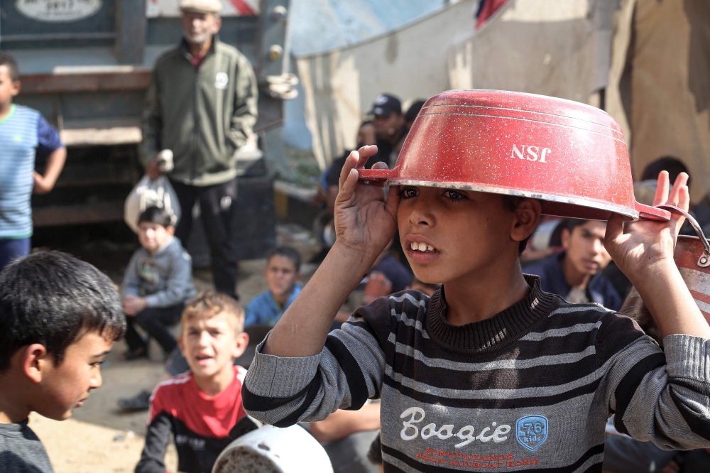 Children gather to receive aid food at Bureij refugee camp in the central Gaza Strip on November 6, 2024, amid the ongoing conflict in the Palestinian territory between Israel and Hamas. — AFP pic