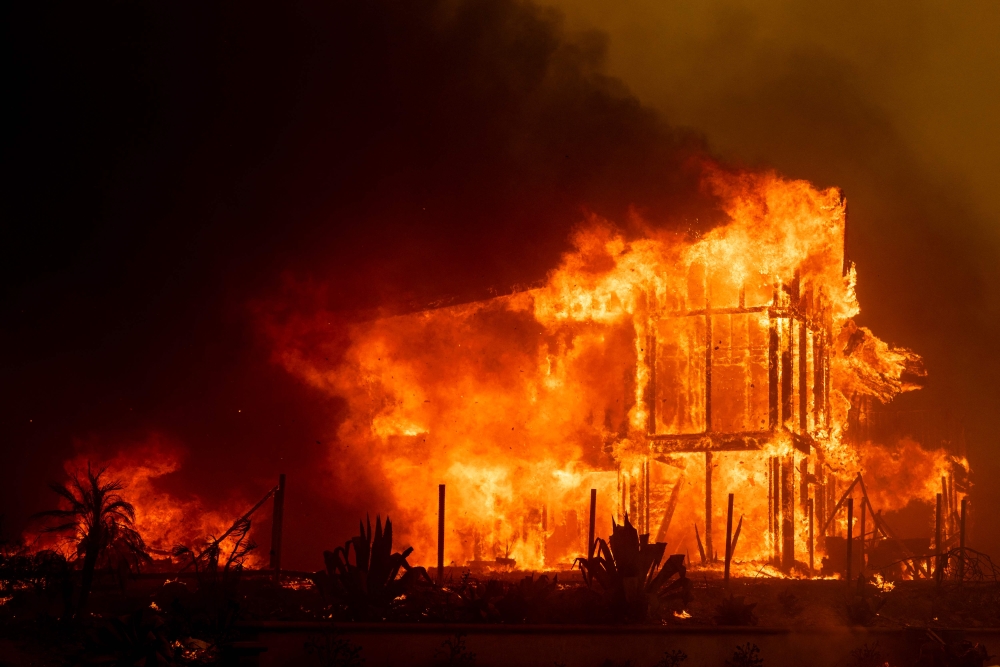 A house is engulfed in the flames of the Mountain Fire as the wildfire scorches acres in Camarillo Heights, Camarillo, California November 6, 2024. — AFP pic