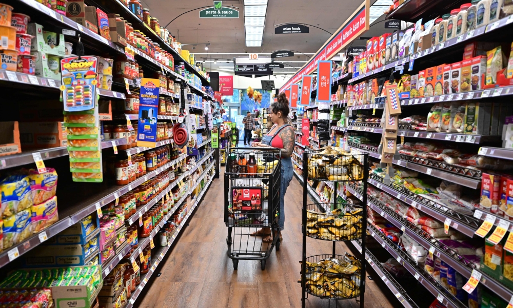 A woman shops for groceries at a supermarket in Monterey Park, California on October 19, 2022. Donald Trump's US election victory was, at least in part, down to his success in pinning the blame for a post-pandemic inflationary surge on the Biden-Harris administration. But analysts say some of Trump's own economic plans, from hiking tariffs to reining in the Fed's independence, risk undoing the US central bank's progress against inflation, potentially pushing it to keep interest rates higher for longer. — AFP pic